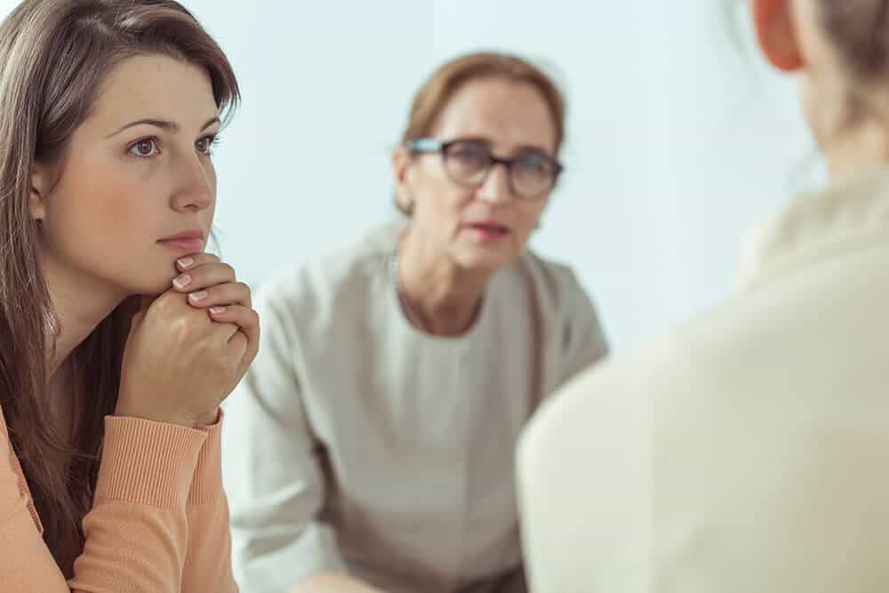 a teenage girl confides to women listening during an Al-Anon meeting 