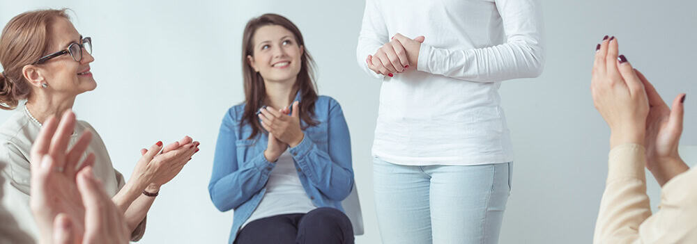 lighthouse-treatment-center-what-is-al-anon-article-image-of-women-clapping-in-al-anon-meeting
