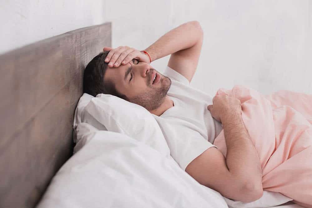 lighthousetreatment-what-is-ayahuasca-article-photo-sick-young-man-headache-concept-621921497