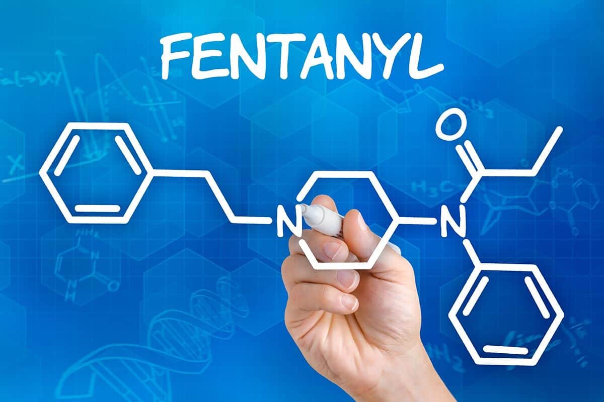 a man drawing the chemical formula for fentanyl