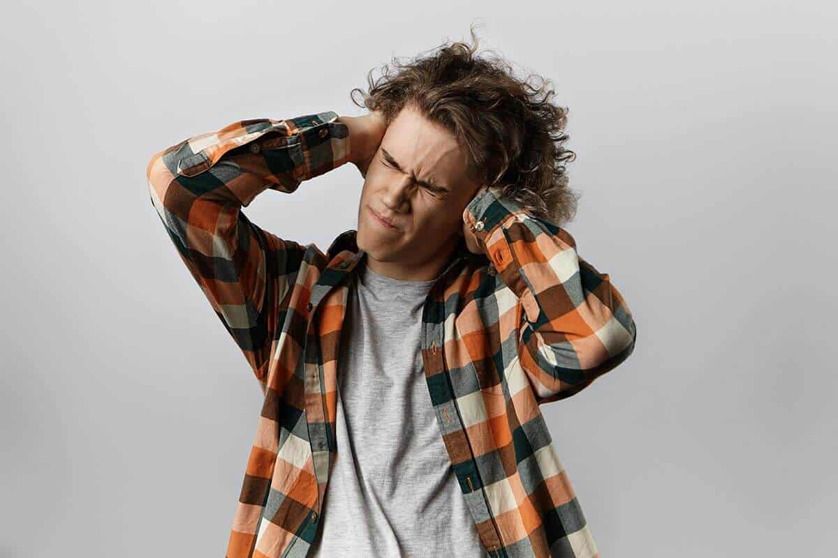 lighthousetreatment-marijuana-withdrawal-symptoms-article-photo-picture-of-irritated-young-caucasian-male-dressed-in-plaid-shirt-closing-eyes-tight-and-squeezing-748910170