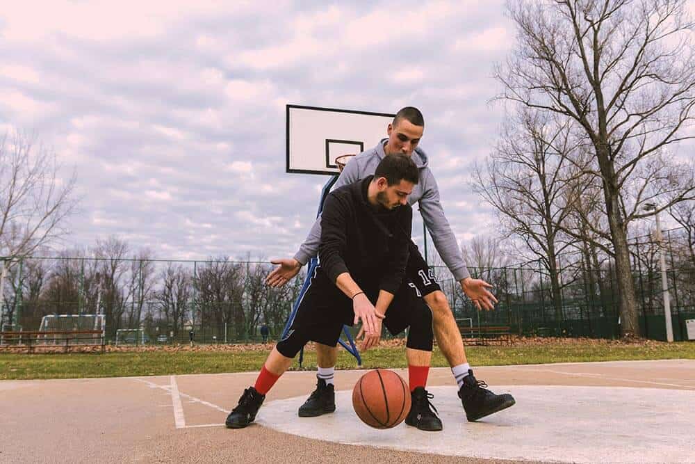 lighthousetreatment-9-ways-to-cope-with-anxiety-without-medication-article-photo-portrait-of-a-two-young-sports-men-playing-basketball-at-the-playground-summer-vacation-sport-789327679
