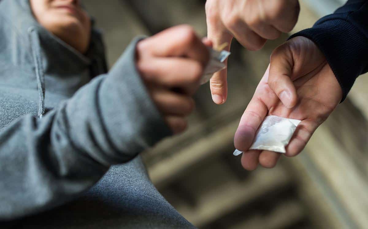 anaheimlighthouse-what-motivates-someone-to-become-a-drug-dealer-photo-sale-concept-close-up-of-addict-with-money-buying-dose-464198144