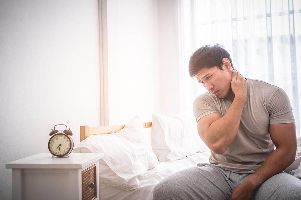 lighthousetreatment-how-long-does-alcohol-detox-take-and-what-happens-article-photo-male-woke-up-by-having-muscle-pain-in-the-neck-1075336850