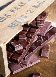 broken bars of chocolate on a wooden table