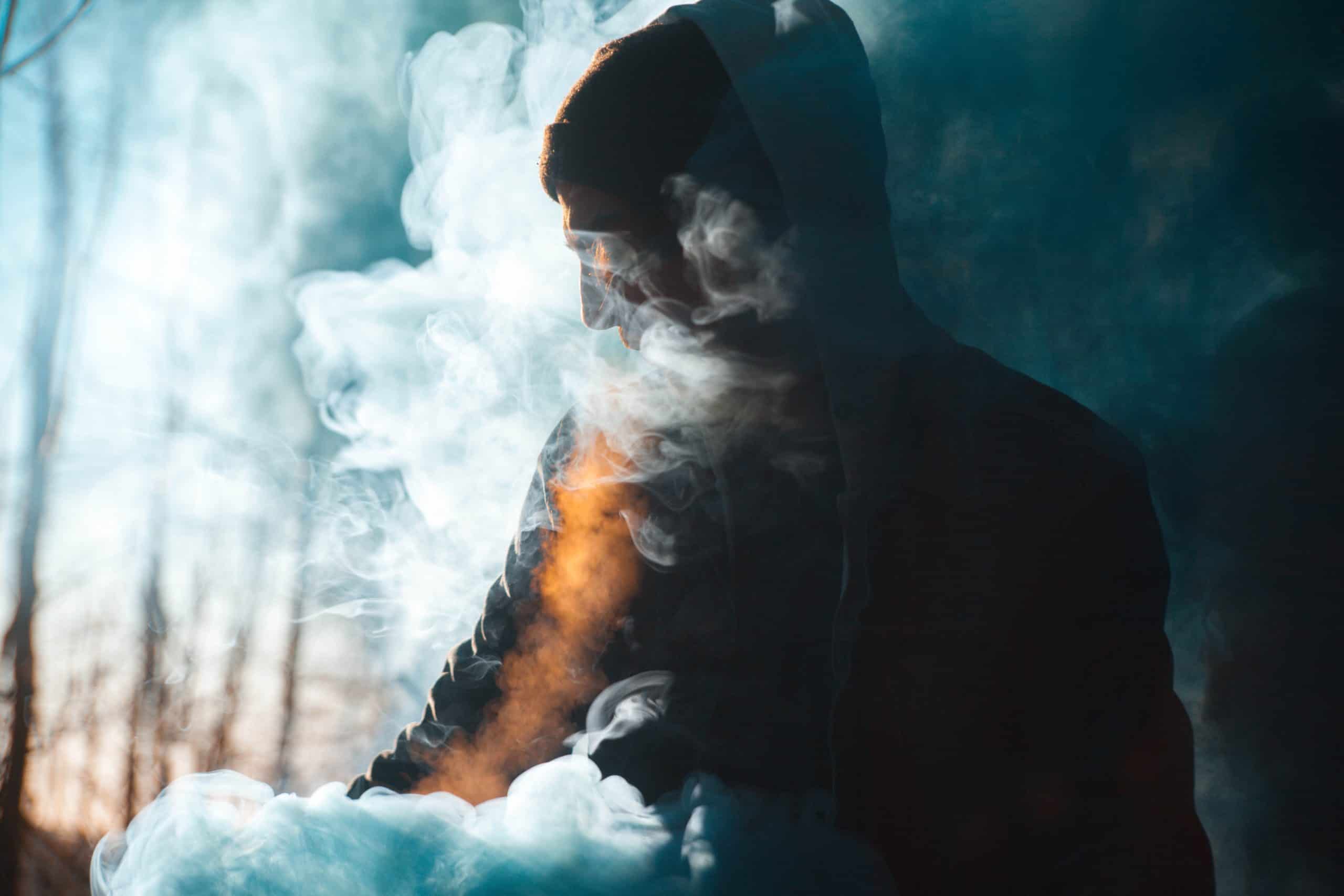 silhouette of a man engulfed in vape smoke