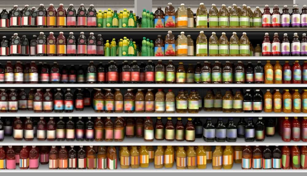 Supermarket shelves with bottles of kombucha and other beverages 