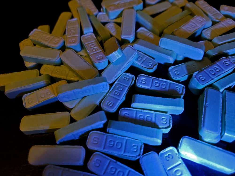 Blue Xanax bars B707 pills on a black surface 