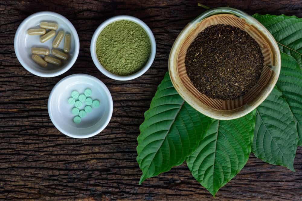 Different kratom products including powder, pills, capsule and tea