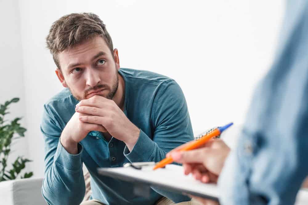 Addicted man in an addiction therapy for treatment