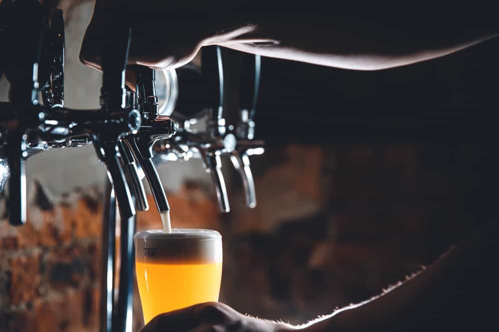 Mug being filled with draft beer 