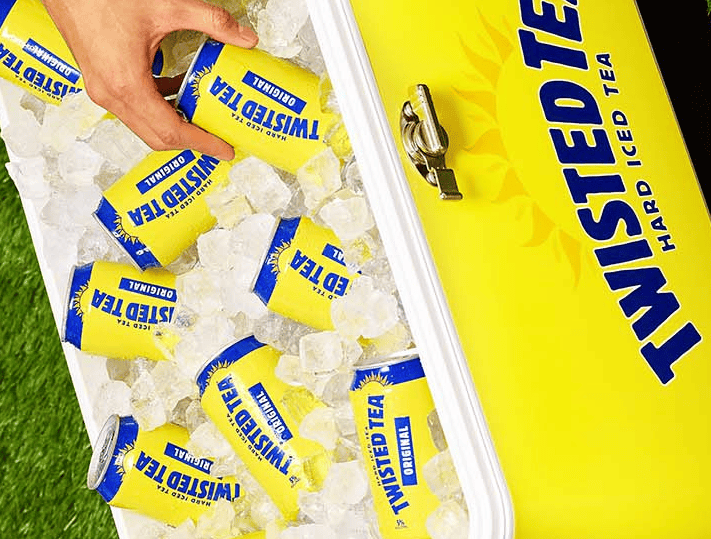 Man getting a can of Twisted Tea from an ice box cooler 