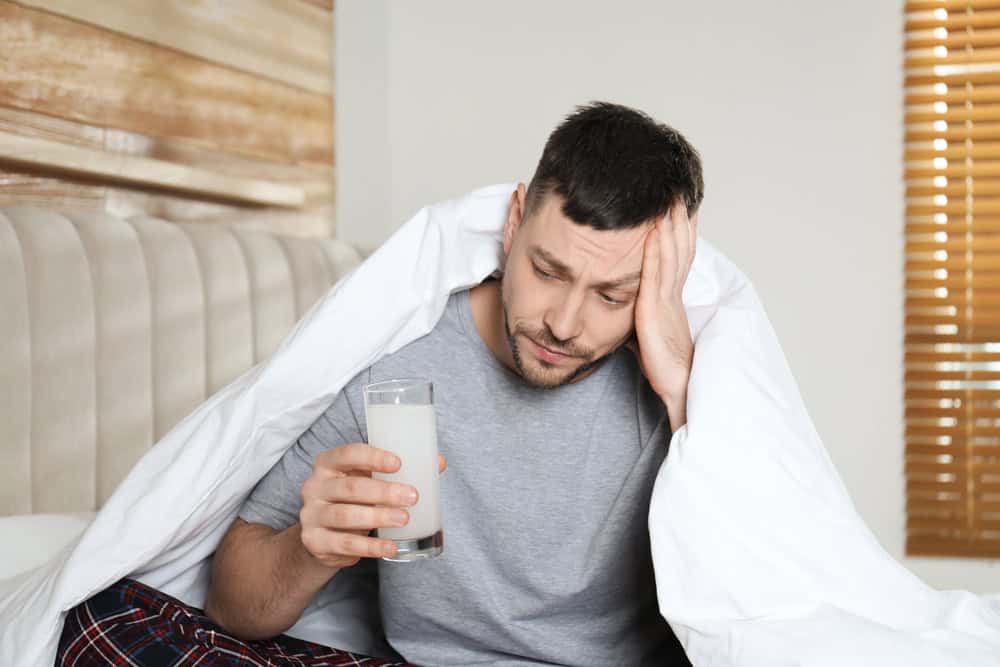 A man with a glass of water for morning hangover