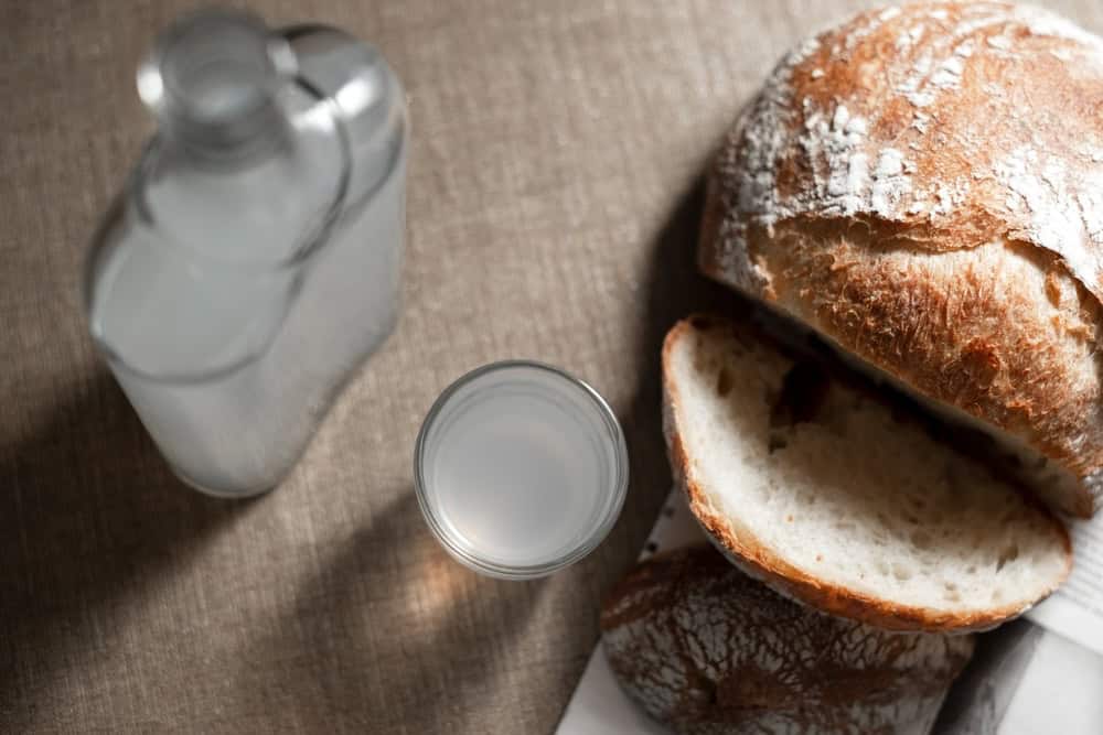 Shots of vodka with bread beside it
