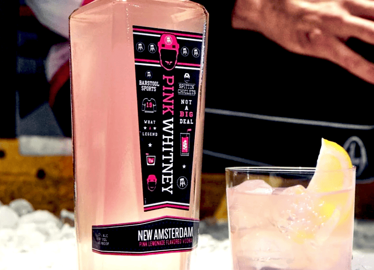A glass of Pink Whitney and a glass filled with alcohol