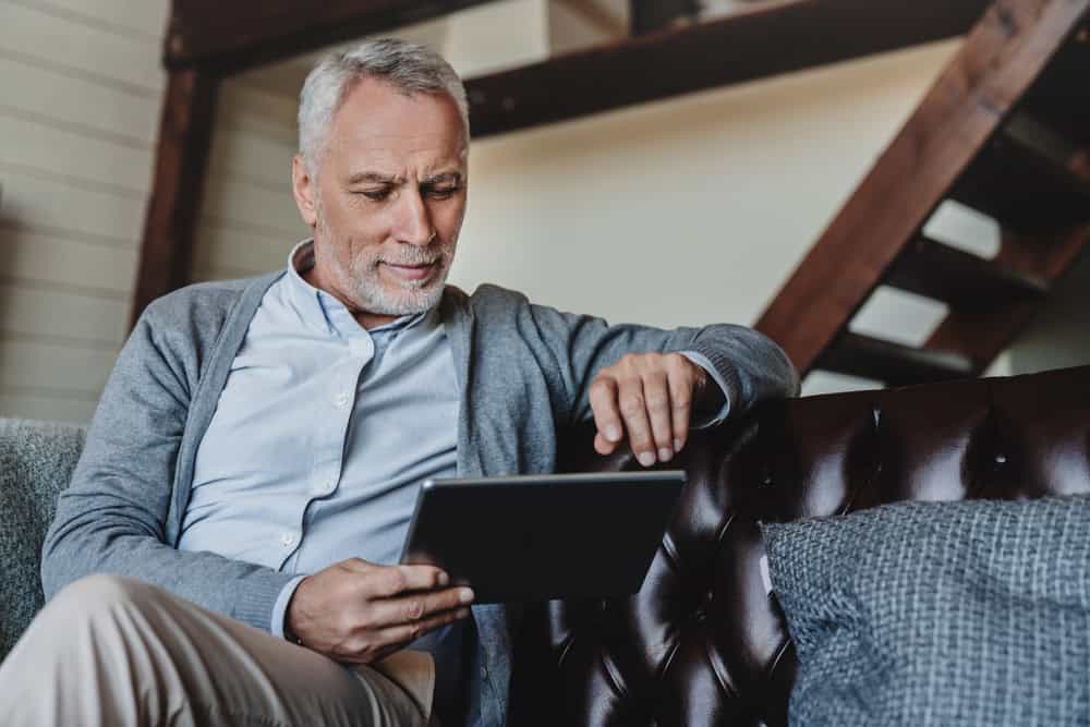 Man looking at a picture frame of a lost loved one