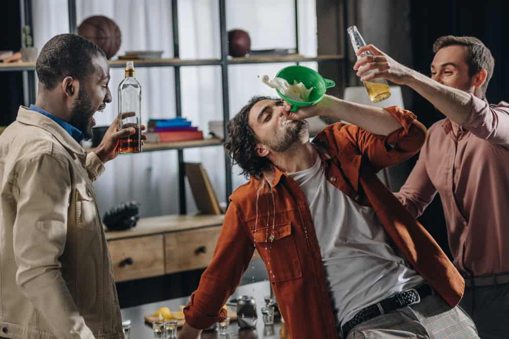 College friends with beer bong binge drinking