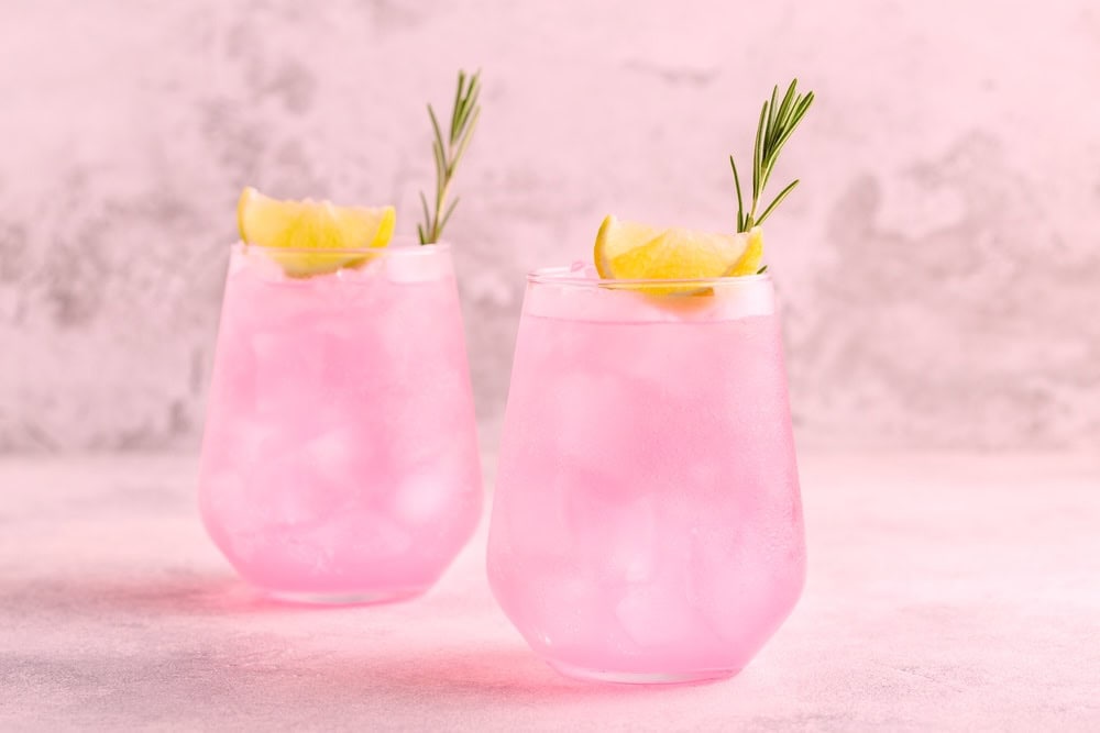 Two glasses of Pink Whitney on a countertop 