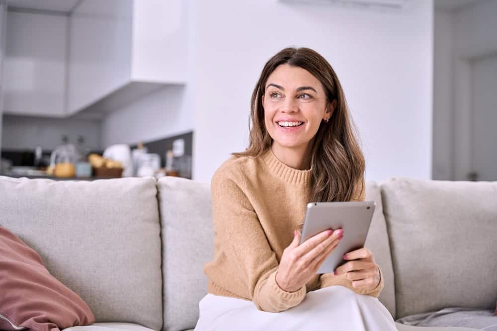 Young woman smiling while reading getting sober quotes