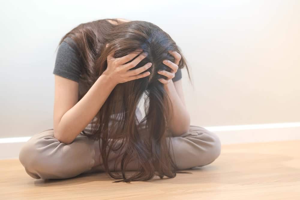 Teen woman sitting with her hair in a mess after green out