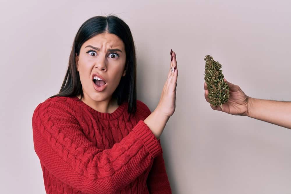 Woman with an aghast expression saying no giving up weed
