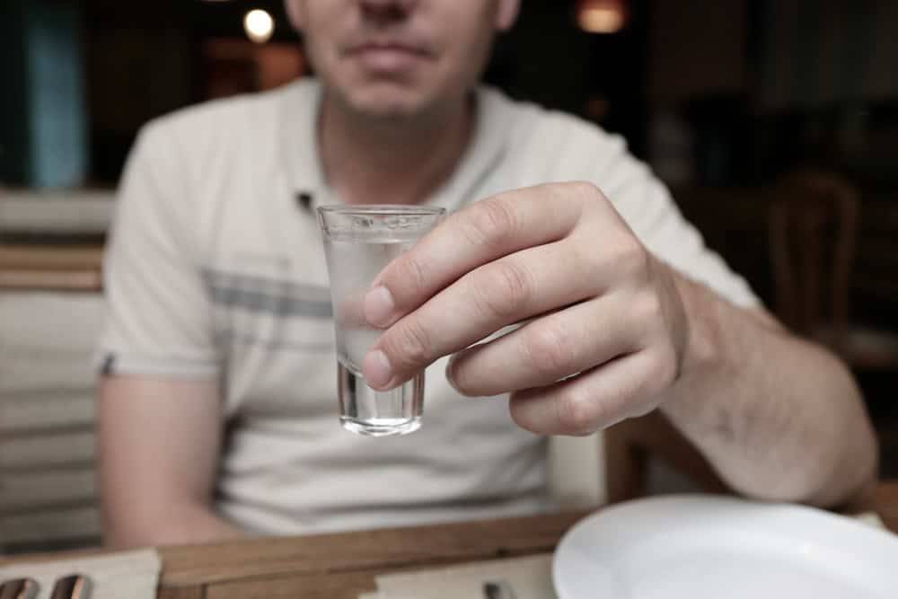 Man drinking gin in a bar wondering about gin alcohol percentage
